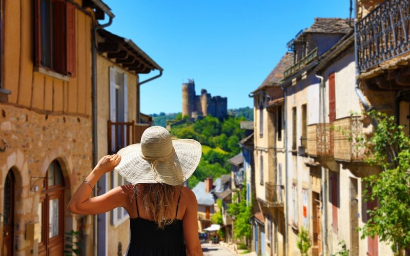 woman tourist in medieval french village- Najac