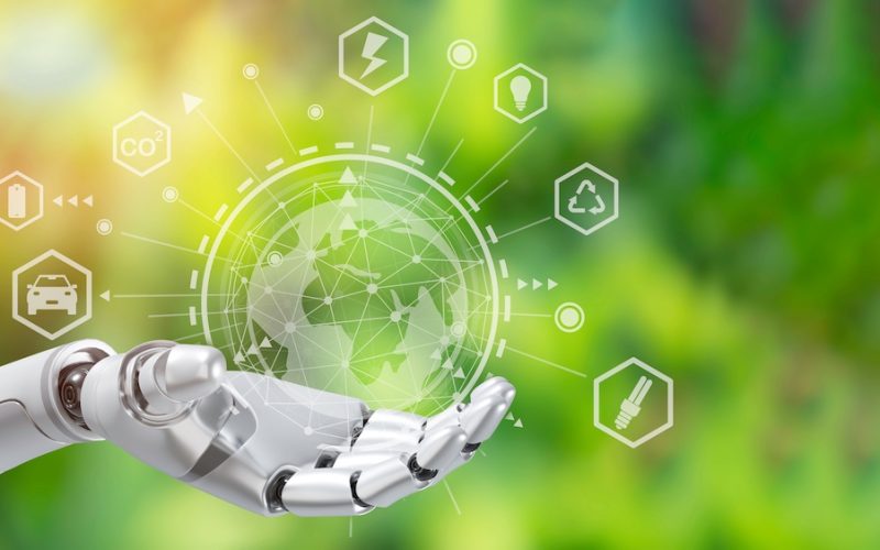 Robot arm holding earth on green tree background,Environment concept, Artificial Intelligence and Technology ecology concept.