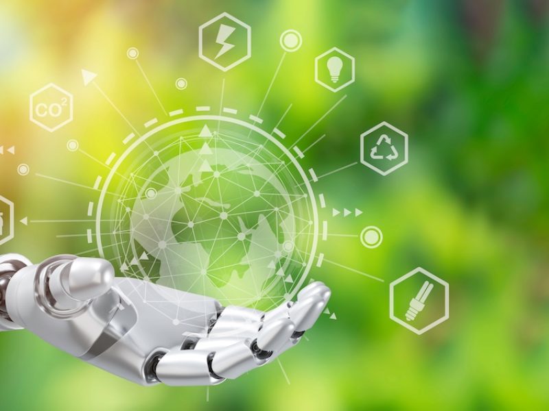 Robot arm holding earth on green tree background,Environment concept, Artificial Intelligence and Technology ecology concept.