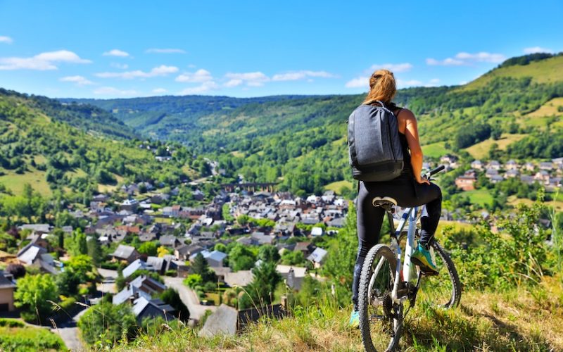 active woman biking countryside- Aveyron in France