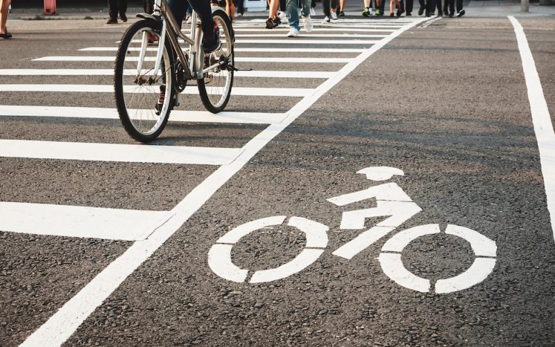 Bike lane street crosswalk with People ride bicycle crossing urban city lifestyle